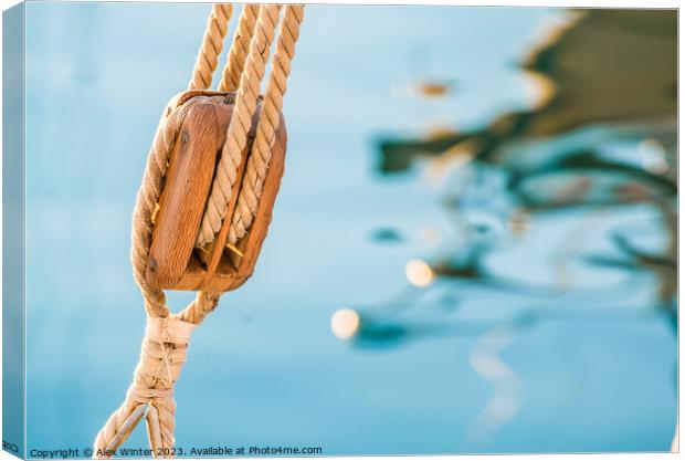 Nautical pulley with ropes of a classic sailing boat and blue sea water background Canvas Print by Alex Winter