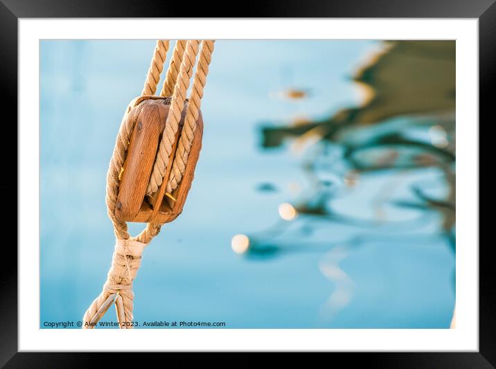 Nautical pulley with ropes of a classic sailing boat and blue sea water background Framed Mounted Print by Alex Winter