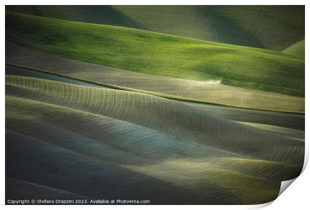 Tractor plowing the fields in Tuscany sunset. Vescona, Siena. Print by Stefano Orazzini
