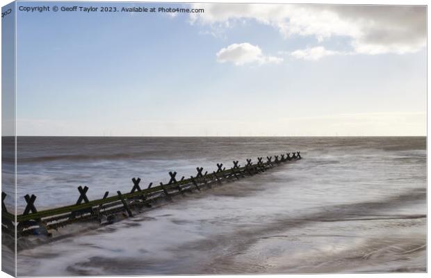 Along the breakwater Canvas Print by Geoff Taylor