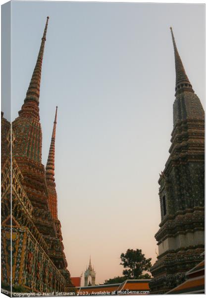 Second view of two stupa against sky at Wat Pho Canvas Print by Hanif Setiawan