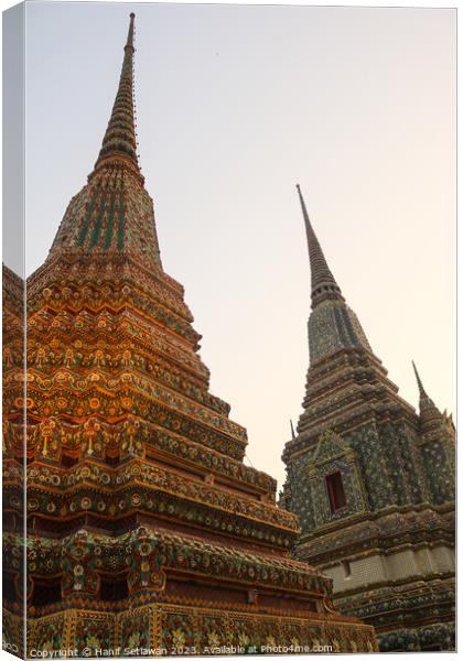 Third view of two stupa against sky at Wat Pho Canvas Print by Hanif Setiawan