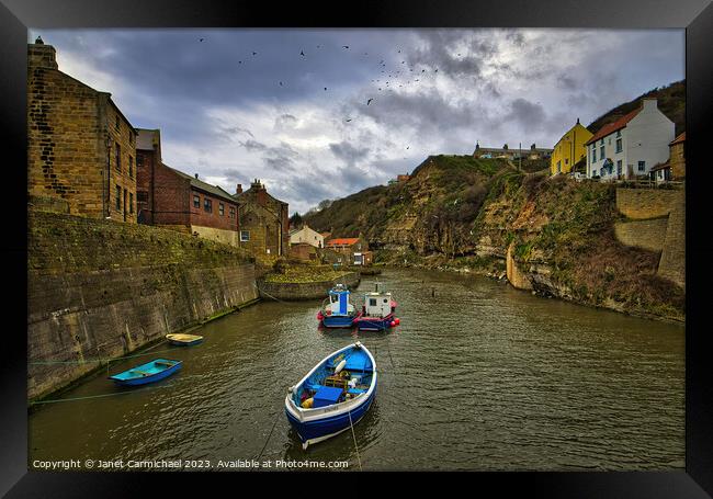 Seagulls Soar Over Stormy Staithes Framed Print by Janet Carmichael