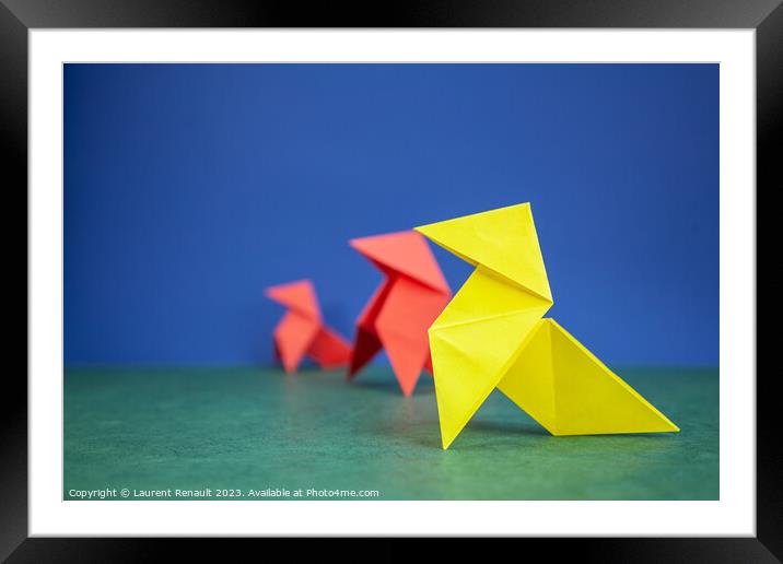 Paper hen origami over green and blue background Framed Mounted Print by Laurent Renault