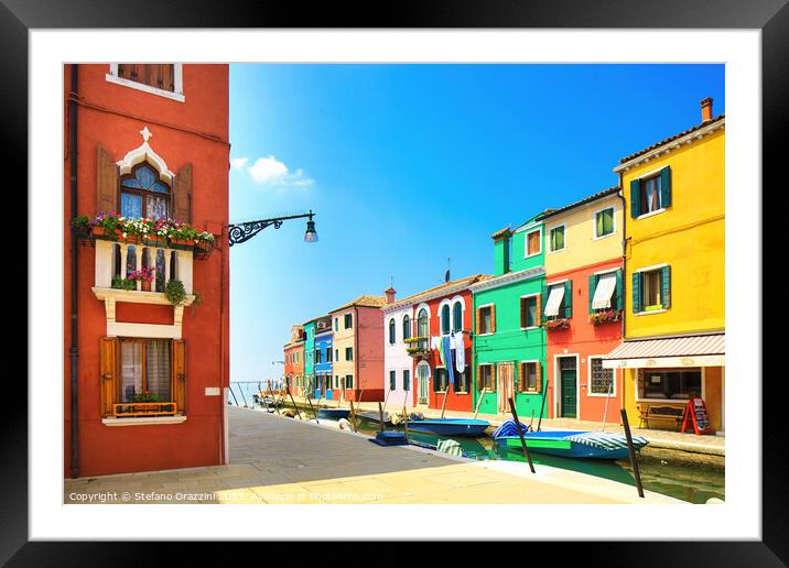 Burano island canal, colourful houses and boats. Framed Mounted Print by Stefano Orazzini