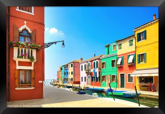 Burano island canal, colourful houses and boats. Framed Print by Stefano Orazzini