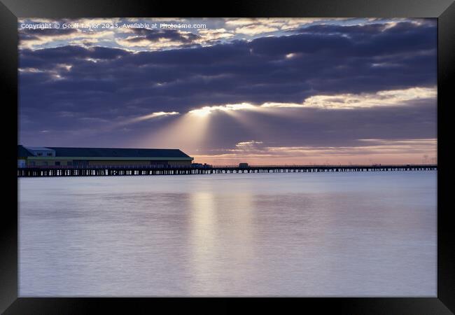 Rays over the pier Framed Print by Geoff Taylor