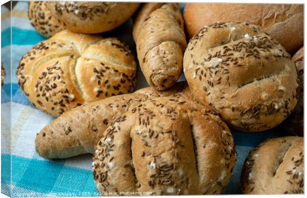 Heap of various bread rolls sprinkled with salt, caraway and sesame. Fresh rustic bread from leavened dough. Assortment of freshly of bakery products Canvas Print by Lubos Chlubny