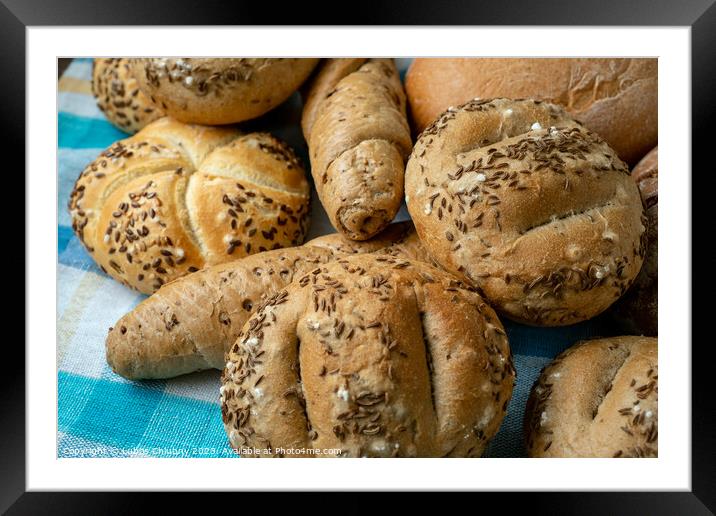 Heap of various bread rolls sprinkled with salt, caraway and sesame. Fresh rustic bread from leavened dough. Assortment of freshly of bakery products Framed Mounted Print by Lubos Chlubny