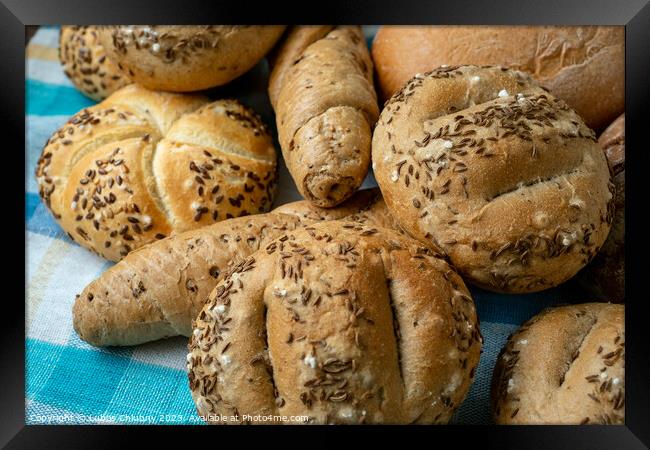 Heap of various bread rolls sprinkled with salt, caraway and sesame. Fresh rustic bread from leavened dough. Assortment of freshly of bakery products Framed Print by Lubos Chlubny
