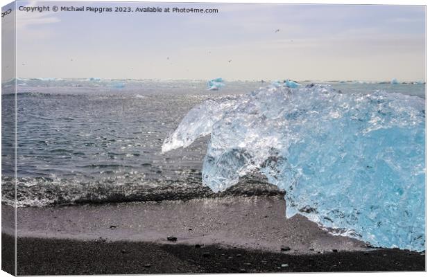 Diamond Beach in Iceland with blue icebergs melting on black san Canvas Print by Michael Piepgras