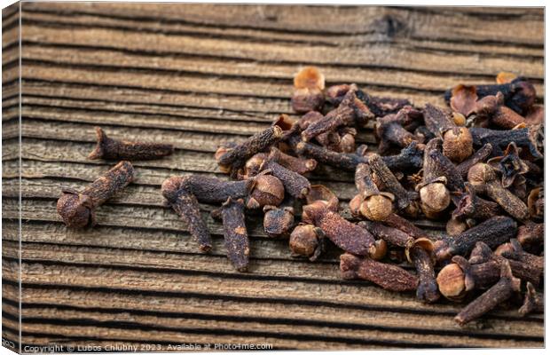 Clove spice on a wooden board, Syzygium aromaticum Canvas Print by Lubos Chlubny