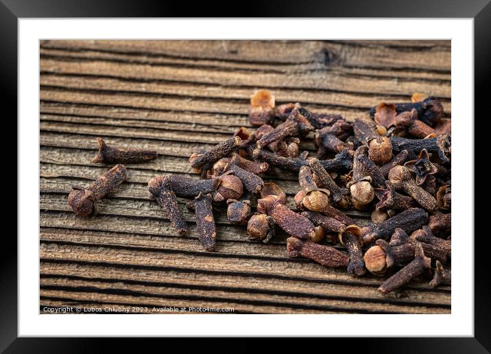 Clove spice on a wooden board, Syzygium aromaticum Framed Mounted Print by Lubos Chlubny