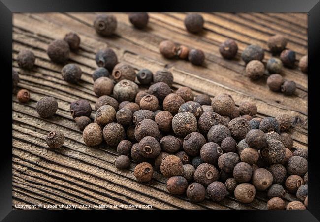 Allspice spice on wooden table Framed Print by Lubos Chlubny