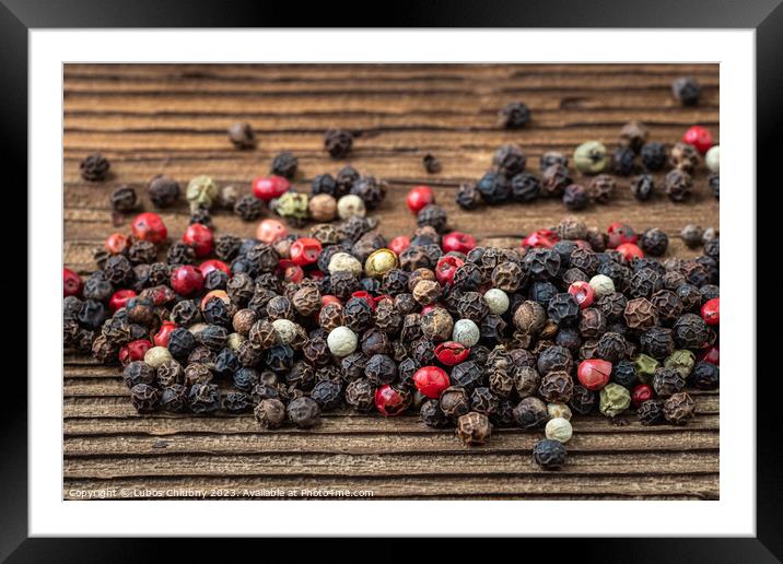 Peppercorns on dark rustic wooden background. Mix of different peppers Framed Mounted Print by Lubos Chlubny
