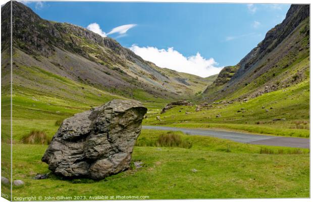 Outdoor mountain with a large rock beside the road in The Lake District Cumbria UK Canvas Print by John Gilham