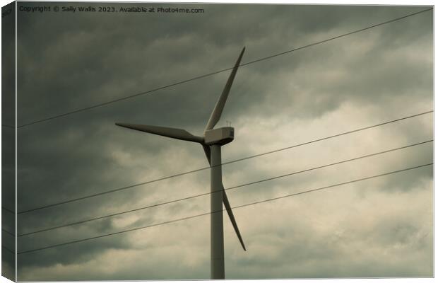 Wind turbine against clouds Canvas Print by Sally Wallis