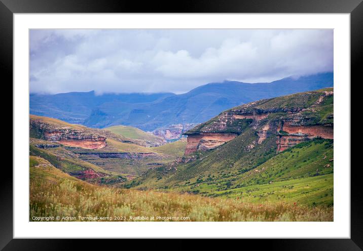 Sandstone cliffs over grassland valley Framed Mounted Print by Adrian Turnbull-Kemp