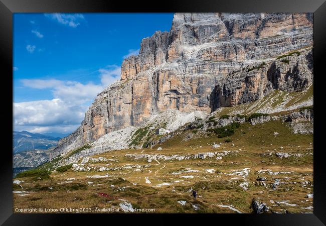 Male mountain climber on a Via Ferrata in breathtaking landscape of Dolomites Mountains in Italy. Travel adventure concept. Framed Print by Lubos Chlubny