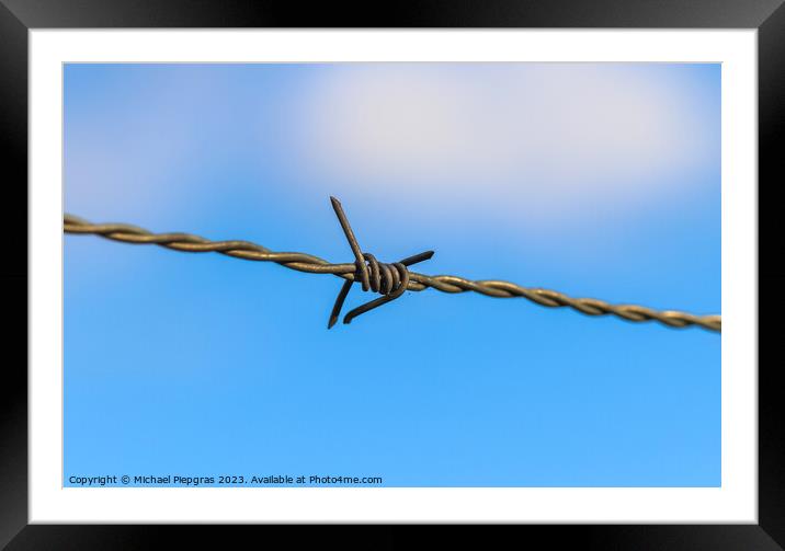 Barbed wire on with a soft focus bokeh in the background. Framed Mounted Print by Michael Piepgras