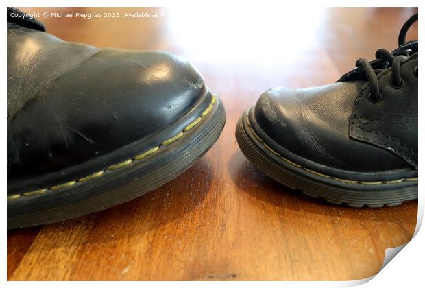 Big and small old black leather shoe on a wooden floor Print by Michael Piepgras