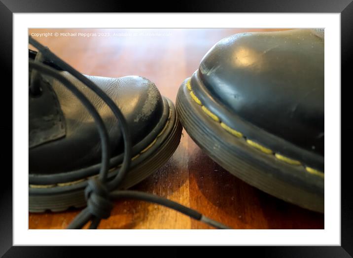 Big and small old black leather shoe on a wooden floor Framed Mounted Print by Michael Piepgras