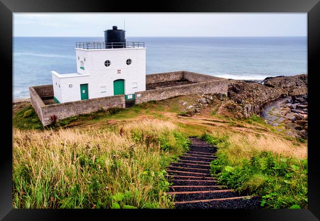 Bamburgh Lighthouse Overlooking Black Rocks Framed Print by Tim Hill