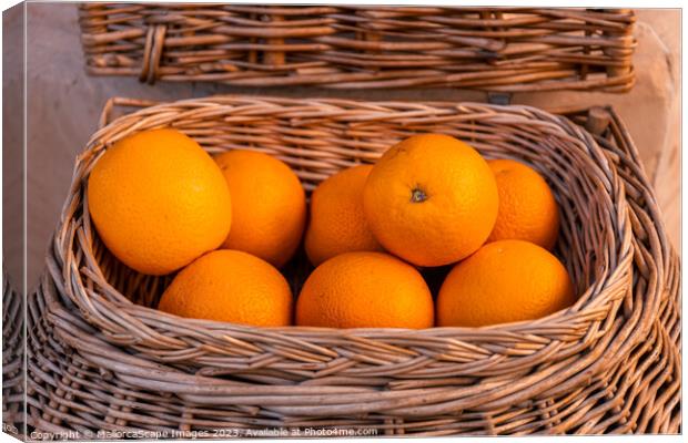 Fresh oranges in a wicker basket Canvas Print by MallorcaScape Images