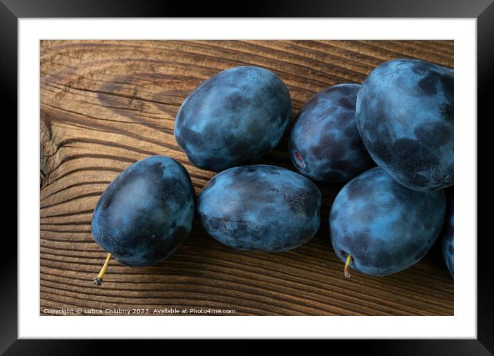 Ripe plums on a wooden table Framed Mounted Print by Lubos Chlubny