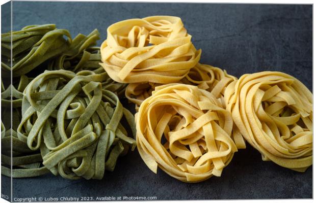 Fresh homemade green and yellow pasta tagliatelle. Raw homemade  Canvas Print by Lubos Chlubny