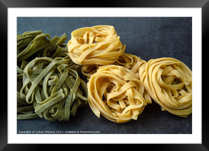 Fresh homemade green and yellow pasta tagliatelle. Raw homemade  Framed Mounted Print by Lubos Chlubny