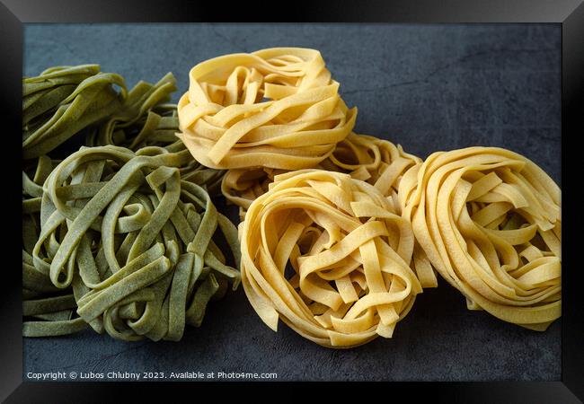 Fresh homemade green and yellow pasta tagliatelle. Raw homemade  Framed Print by Lubos Chlubny