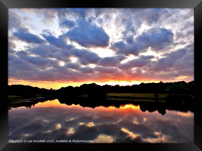 Sunset and lake reflection  Framed Print by Les Schofield