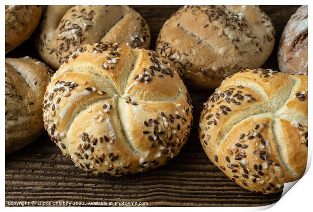 Different bread on a rustic wooden background. Bakery assortment of bread. Print by Lubos Chlubny