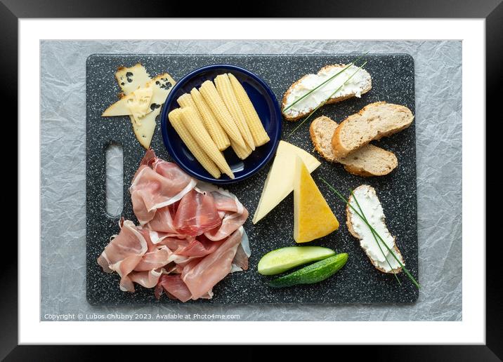 Cold appetizer. Cold cuts. Spicy food on black background, top view. Framed Mounted Print by Lubos Chlubny