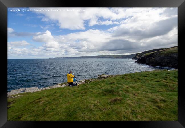 A Serene Fishing Spot on Cornwalls Rugged Headland Framed Print by Derek Daniel