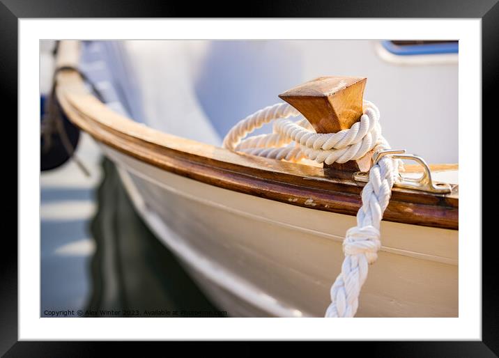 White mooring rope is knotted on boat cleat Framed Mounted Print by Alex Winter