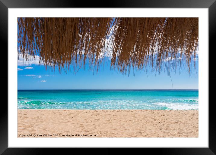 Beautiful sand beach sun, blue sky and straw umbre Framed Mounted Print by Alex Winter