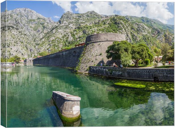 Tourists sit next to the moat in Kotor Canvas Print by Jason Wells