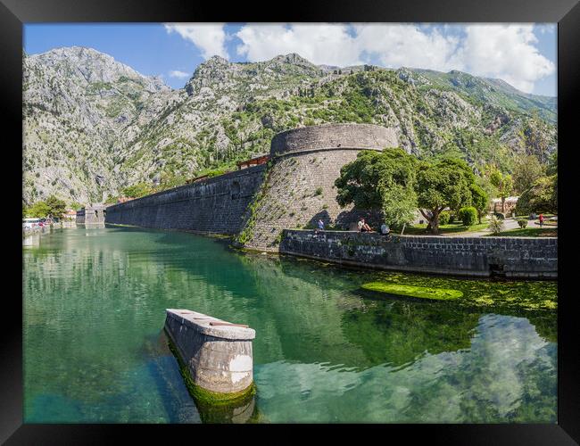 Tourists sit next to the moat in Kotor Framed Print by Jason Wells