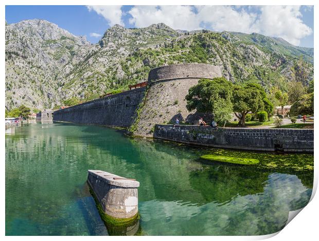 Tourists sit next to the moat in Kotor Print by Jason Wells