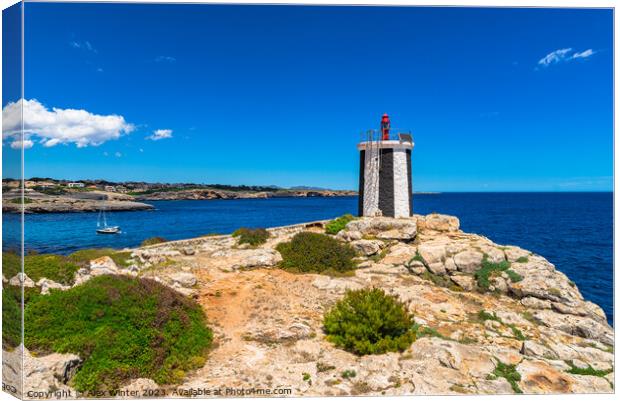 Beautiful view of lighthouse at the rocky coast Canvas Print by Alex Winter