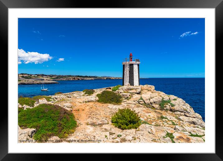 Beautiful view of lighthouse at the rocky coast Framed Mounted Print by Alex Winter