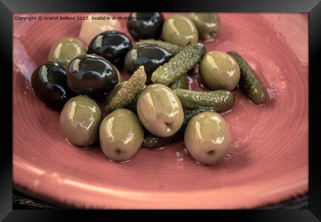 Close-up shot of mix of black and green olives with pickle in an orange bowl. Framed Print by Kristof Bellens
