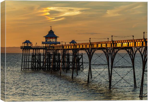 Clevedon Pier at sunset and sunlight reflecting onto the side panels Canvas Print by Rory Hailes
