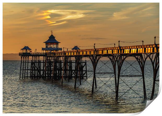 Clevedon Pier at sunset and sunlight reflecting onto the side panels Print by Rory Hailes