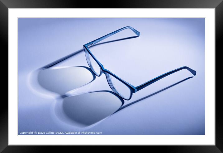 Artistic blue toned pair of blue glasses with shadows Framed Mounted Print by Dave Collins