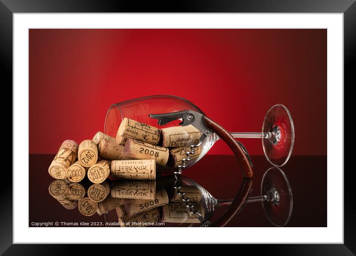 Large wine glass filled with corks and a waiter's  Framed Mounted Print by Thomas Klee