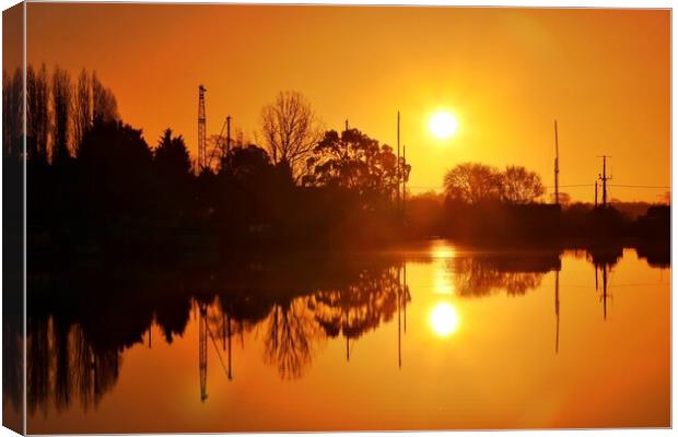 Sunrise reflections over St Osyth Boatyard in essex  Canvas Print by Tony lopez
