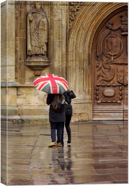 Union jack umbrella outside Bath Abbey Canvas Print by Duncan Savidge